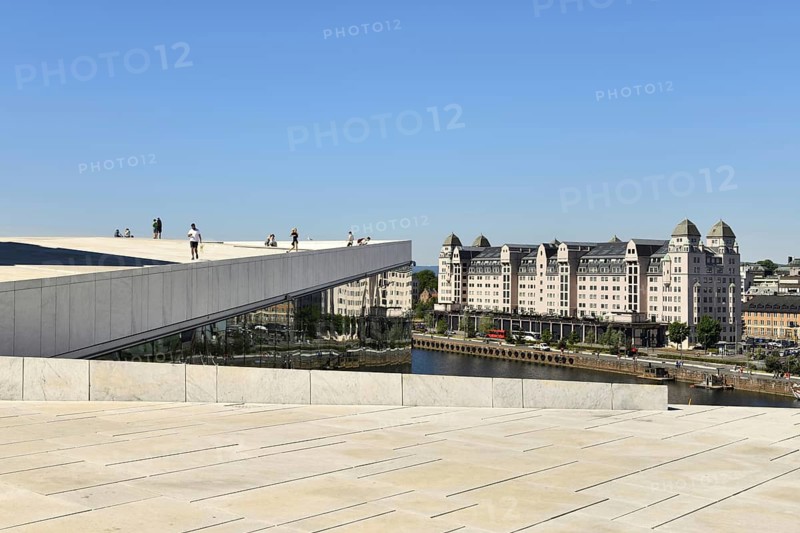 Forecourt and walk-in roof of the new white marble opera house in the back old warehouse district with harbour warehouse