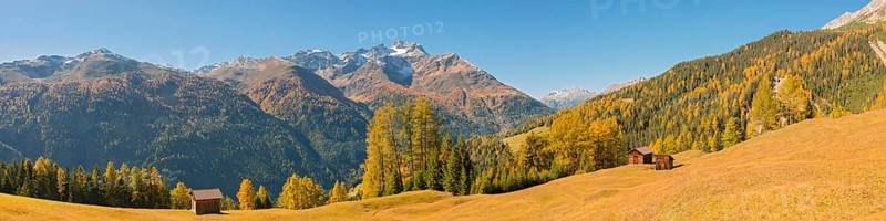 Autumnal mountain landscape with alpine huts