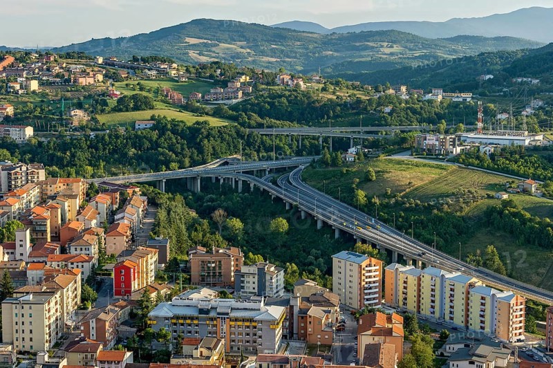 View from Castello Monforte over apartment blocks and motorway junction