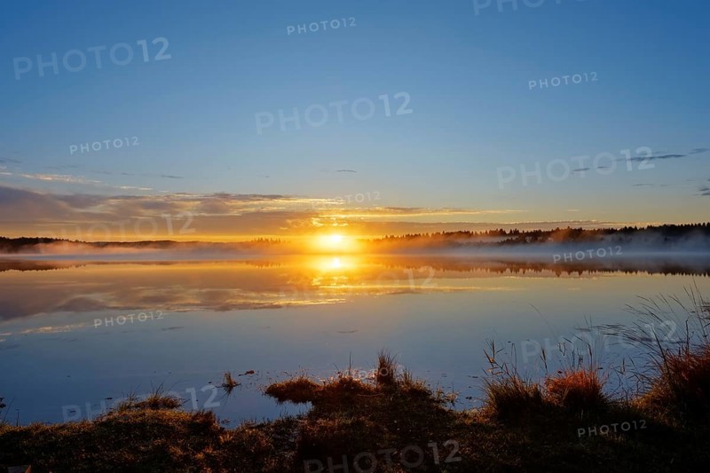 Sunrise with early morning mist over Kirchsee