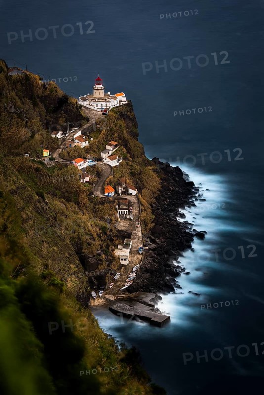 Lighthouse Farol da Ponta do Arnel with sea