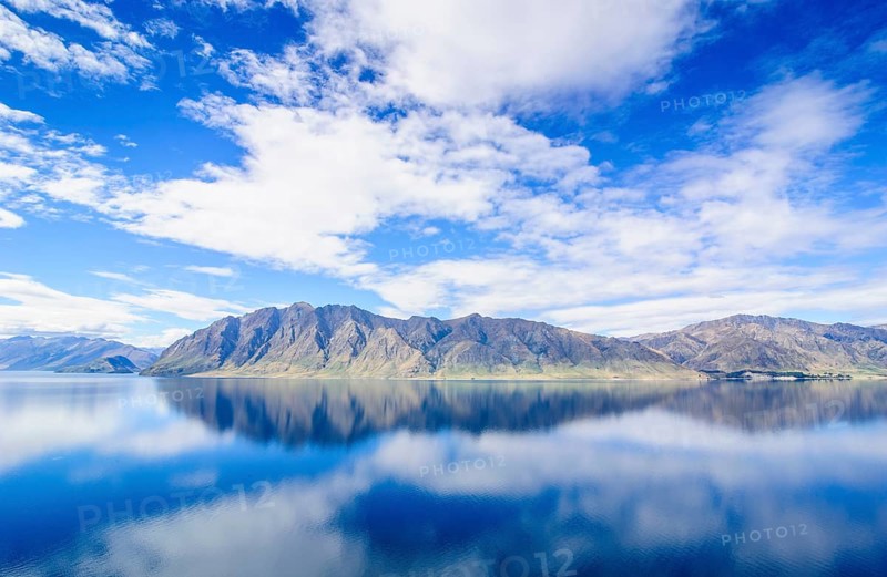 Cloudy sky with water reflections in Lake Hawea