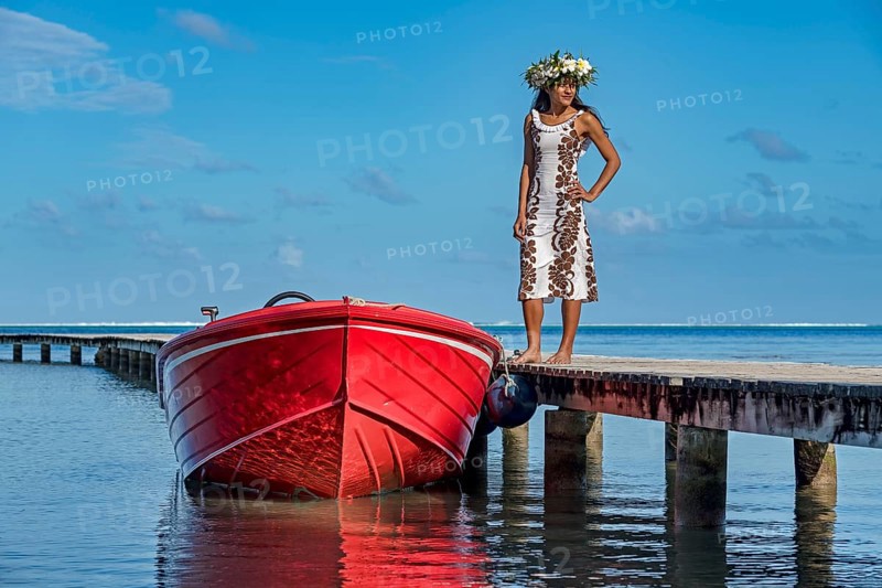 Young woman with flower wreath next to boat