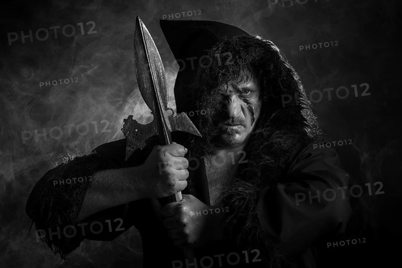 Man with hood and scar in the face