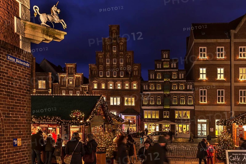 Old gabled houses in Christmas lighting in the evening