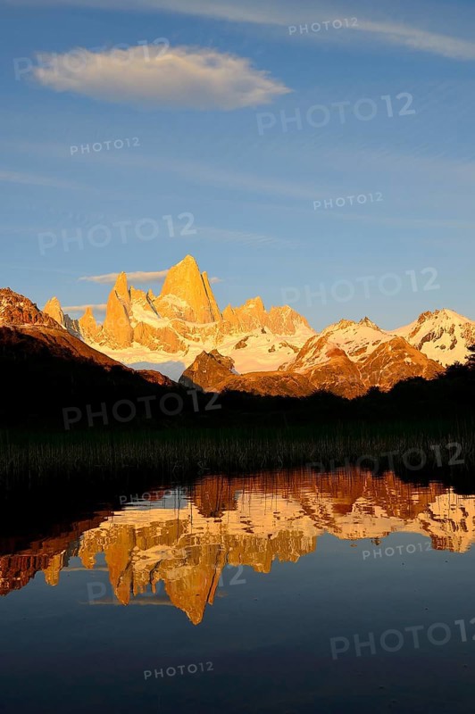 Mountain range with Cerro Fitz Roy at sunrise reflected in Lago de Los Tres