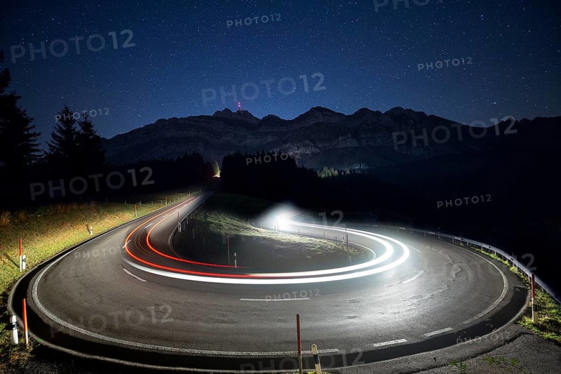 Pass road with cars to Schwagalp with stars and Milky Way