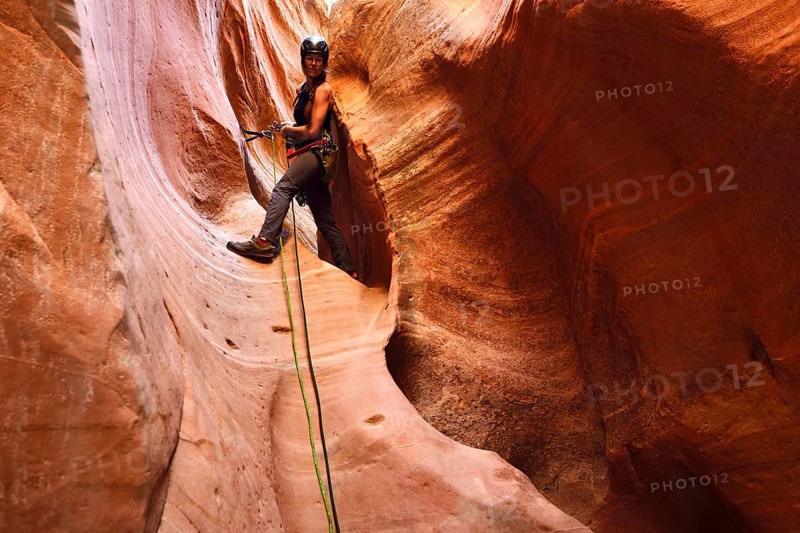 Woman climbing in Huntress Slot Canyon outside Zion National Park