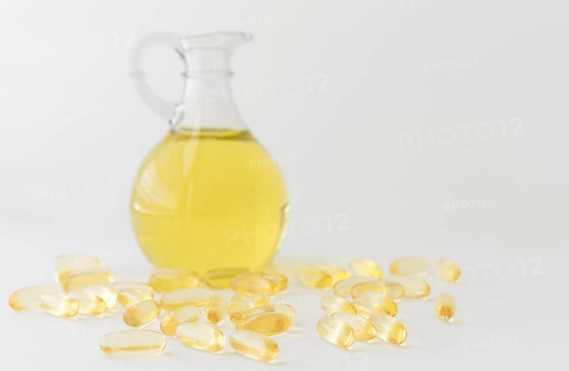 Omega 3 fish oil capsules and bottle on white background