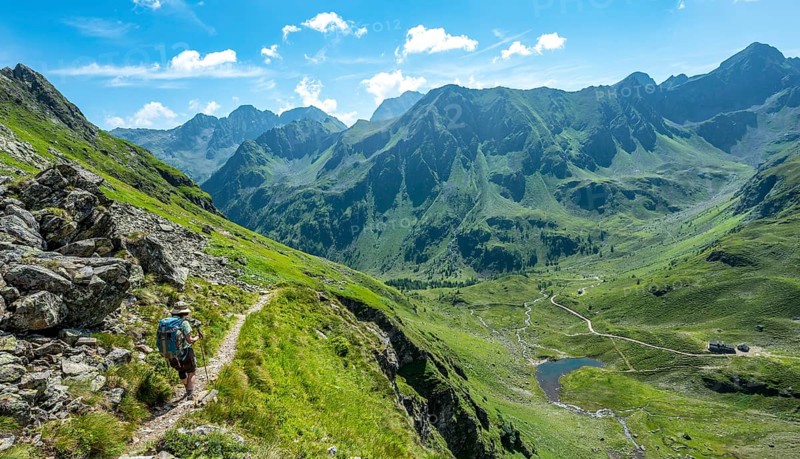 Hiker on the Schladminger Hohenweg on the descent to the Keinprechthutte Schladminger Tauern