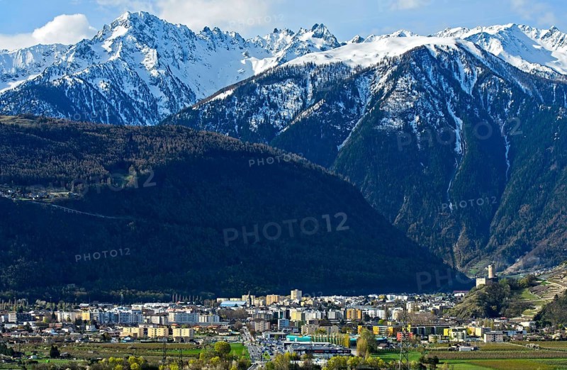 Place Martigny in front of snow-covered Valais Alps