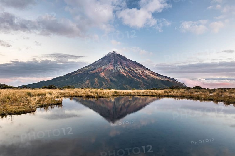 Stratovolcano Mount Taranaki or Mount Egmont reflected in Pouakai Tarn