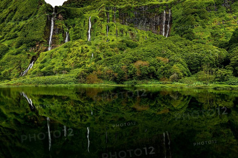 Waterfalls with lake Poco Ribeira do Ferreiro in green landscape