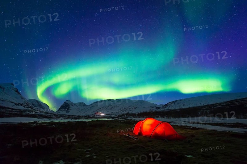 Northern Lights (Aurora borealis) over a tent in winter