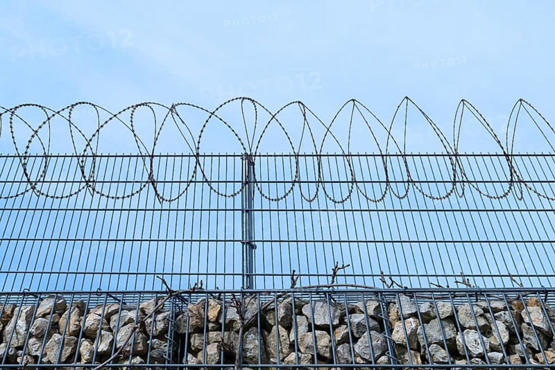 Barbed wire secured stone wall