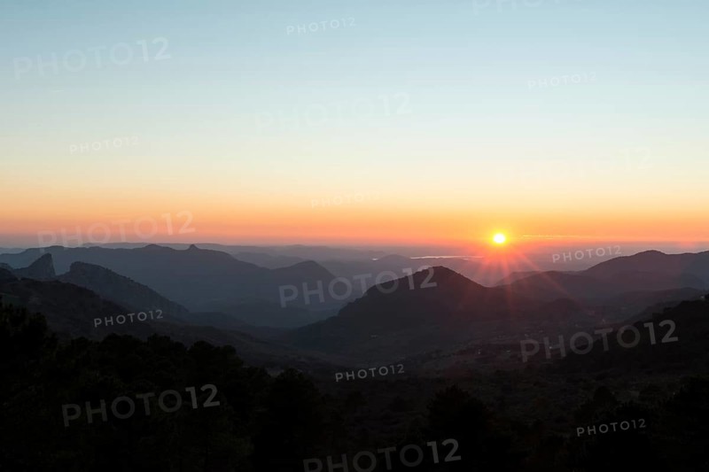 Wooded mountain landscape at sunset