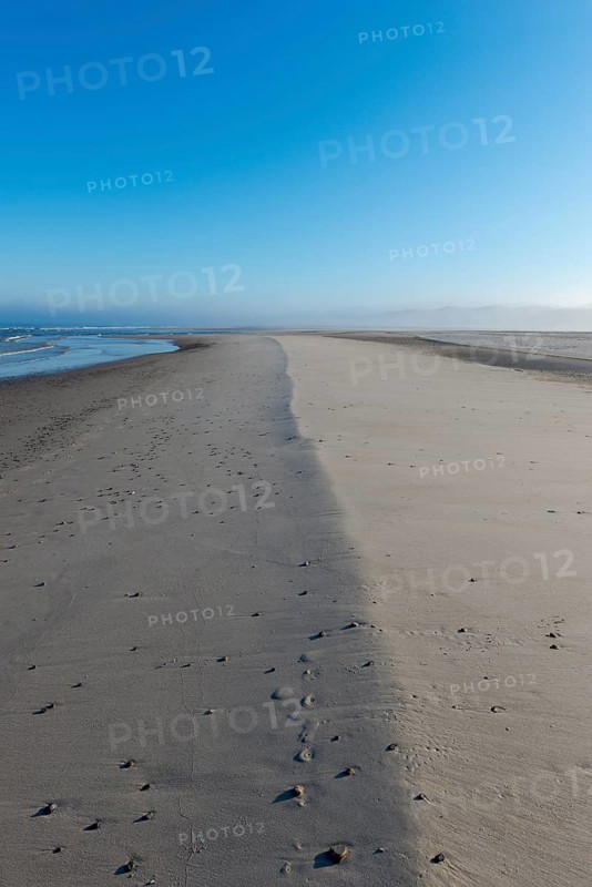 Early mist over the empty beach