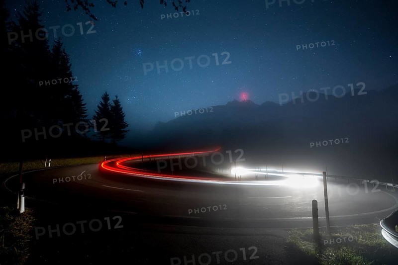 Pass road with cars to Schwagalp with stars and Milky Way