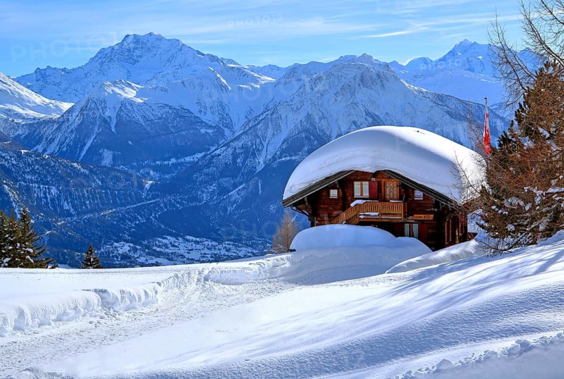 Winter landscape with deep snow-covered chalet in front of Fletschhorn 3985m and Dom 4545m