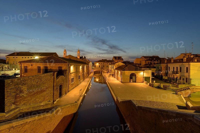 View from the Trepponti bridge on canal with village at dusk