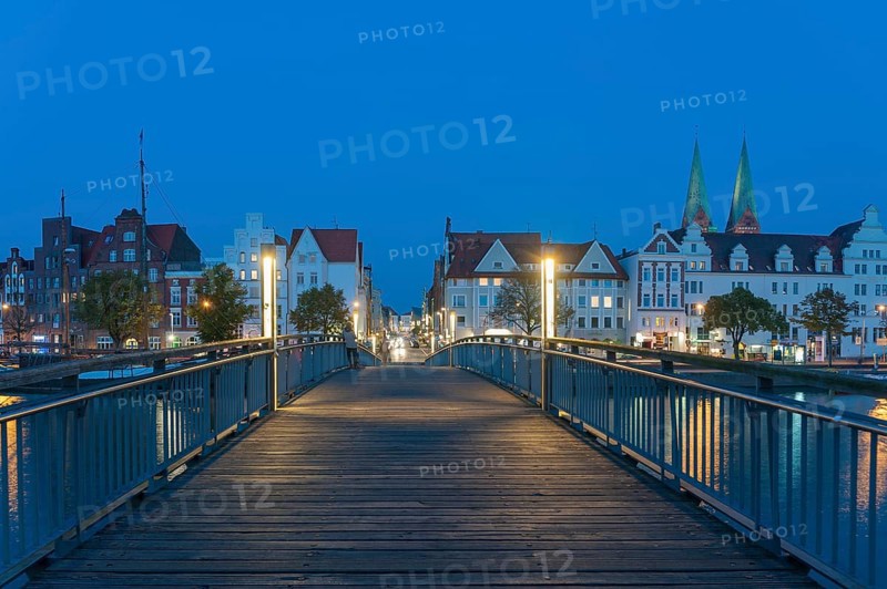 Historical houses with pedestrian bridge over the Trave