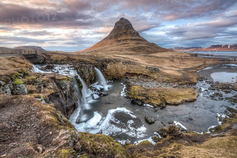 Kirkjufell mountain with Kirkjufellfoss waterfall at sunset