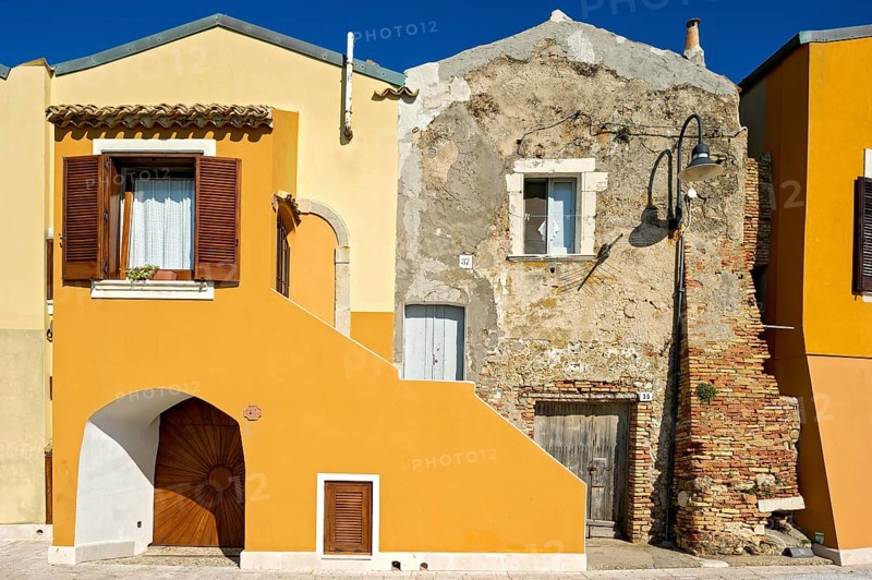 Decayed and renovated house next to each other