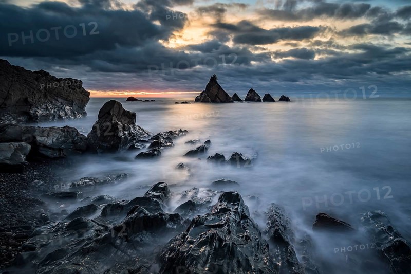 Crumbled coast at sunset