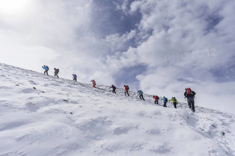 Hiking group ascending to the little Konigstuhl during fresh snowfall