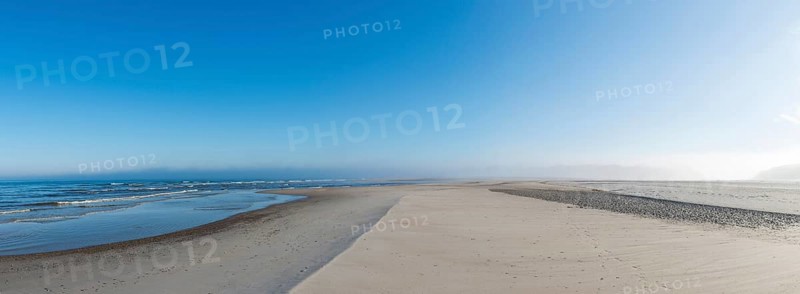 Early mist over the empty beach