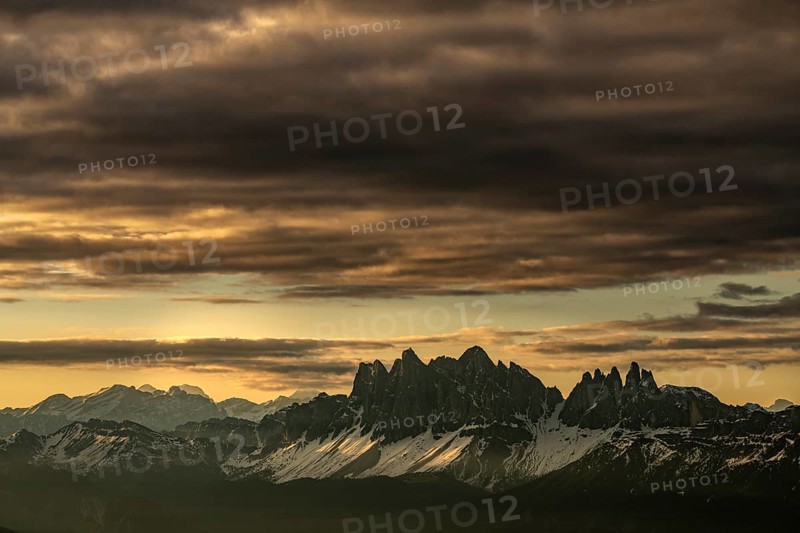 Sunrise with dramatic clouds over South Tyrolean mountain range