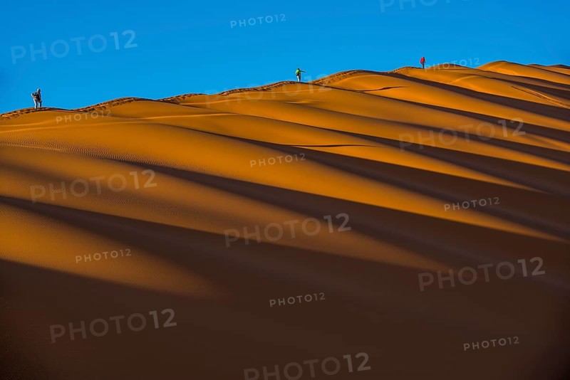 Tourists climb on a sand dune in the Sossusvlei