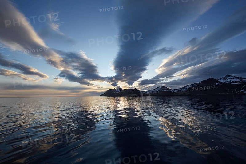 Sunrise at Stromness with cloud formations and reflections in the bay