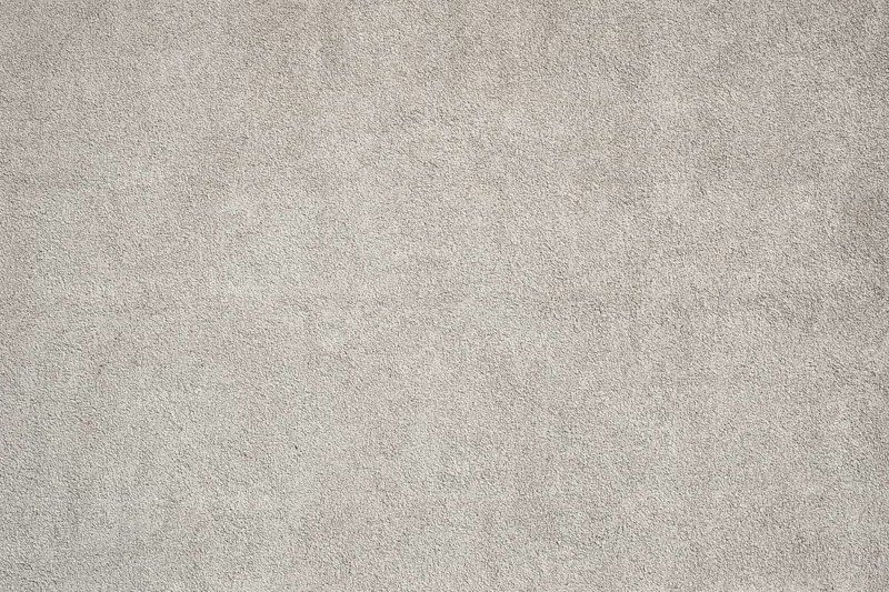 Surface of a medium gray rough plaster wall