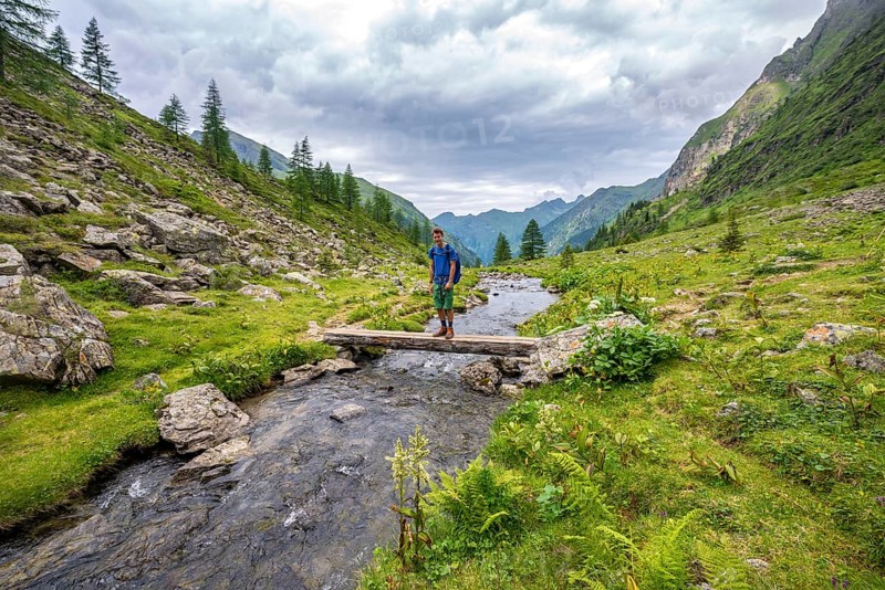 Hiker on a bridge over the Steinriesenbach
