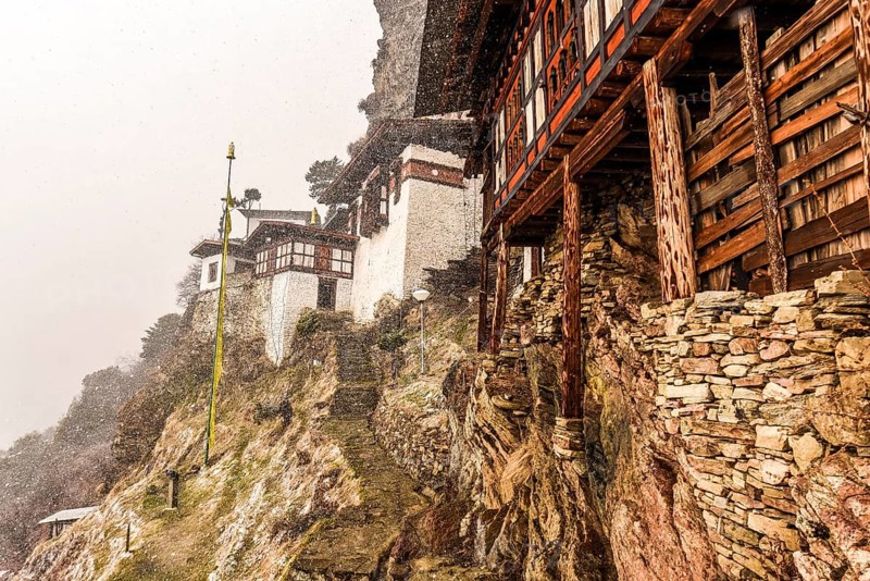 Buddhist nunnery in the mountains during snowfall