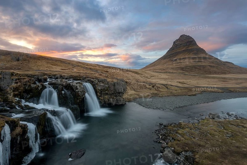 Kirkjufell mountain with Kirkjufellfoss waterfall at sunset