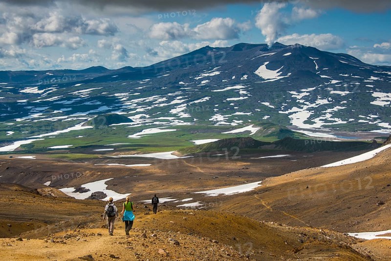 Tourists hiking to the smoking Gorely volcano