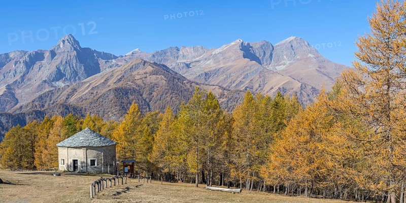 View of Monte Cersogno and Pelvo di Elva in autumn with chapel Chiesa San Giovanni