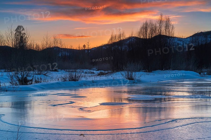 Icy landscape with dramatic sunset