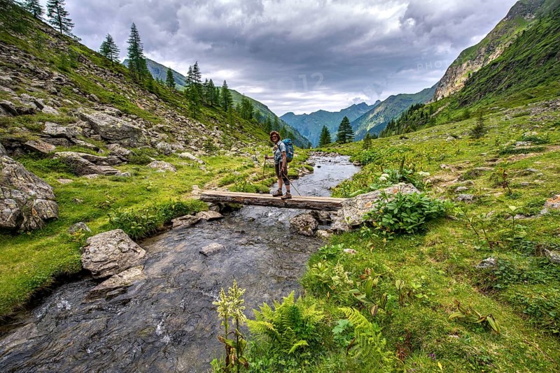 Hiker on a bridge over the Steinriesenbach