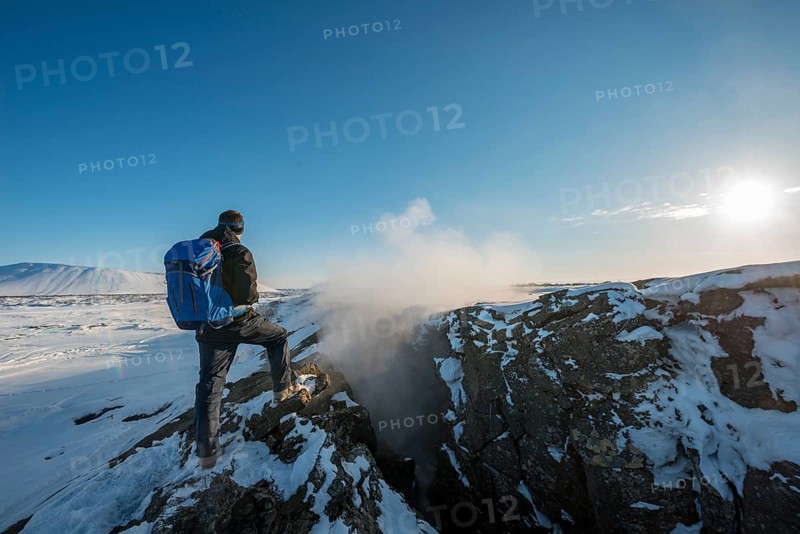 Mountain hiker stands at Continental Rift between North American and Eurasian Plate
