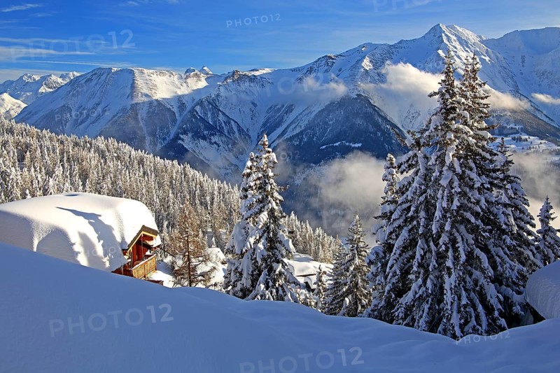 Winter landscape with snow-covered chalet