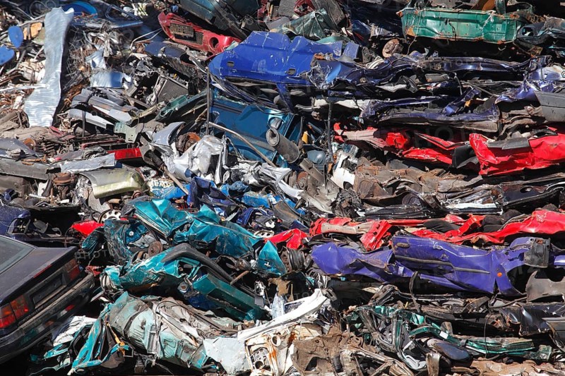 Stacked car wrecks at a scrap yard