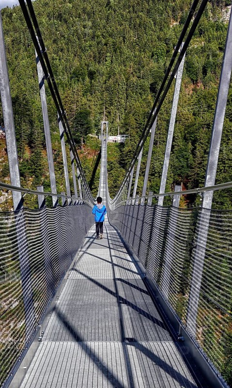 Child on suspension bridge Highline 179