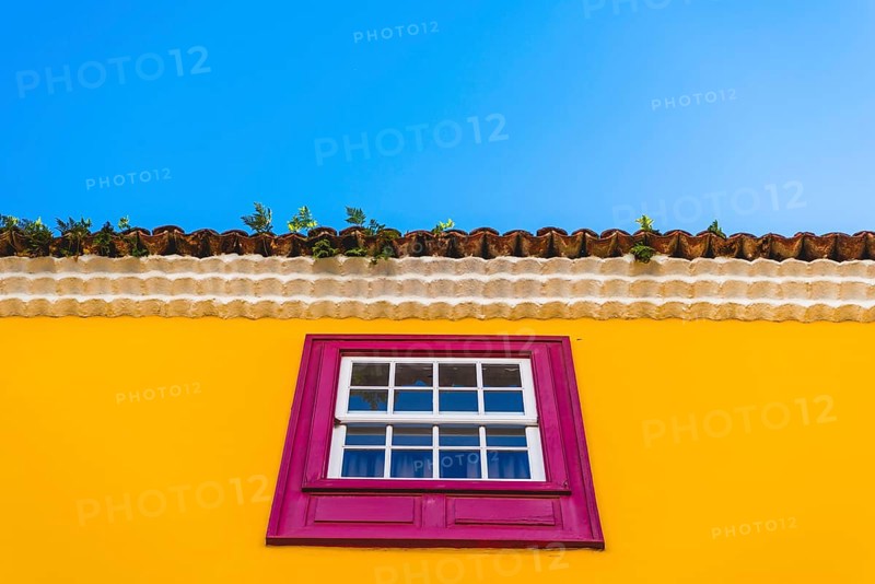 Yellow facade with pink window