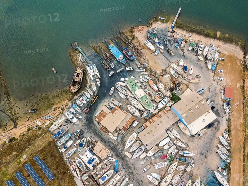 Aerial view of dry docks and shipyard with many boats in Olhao