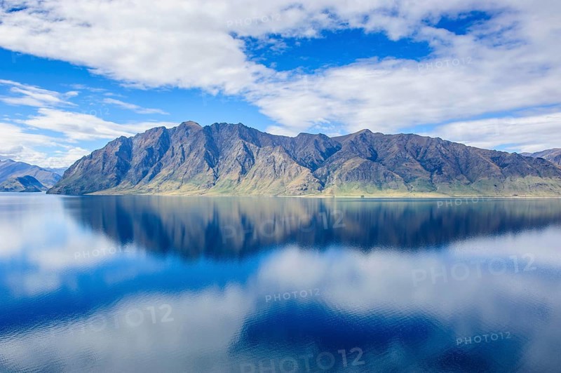 Cloudy sky with water reflections in Lake Hawea