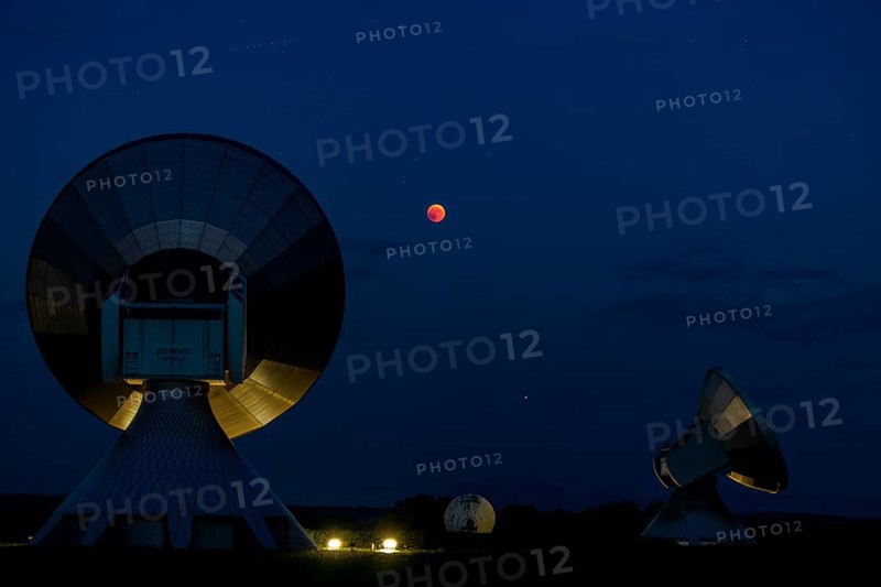 Parabolic antennas with blood moon at lunar eclipse