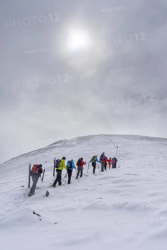 Hiking group ascending to the little Konigstuhl during fresh snowfall